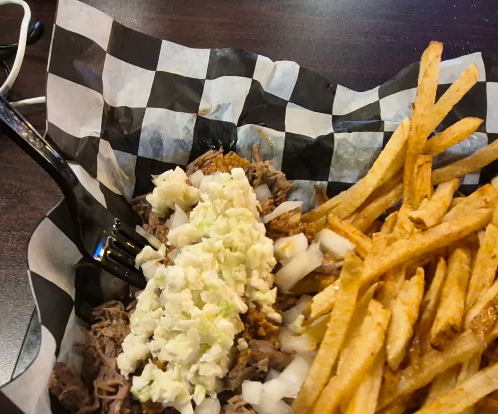 Stew beef basket topped with slaw, fries beside