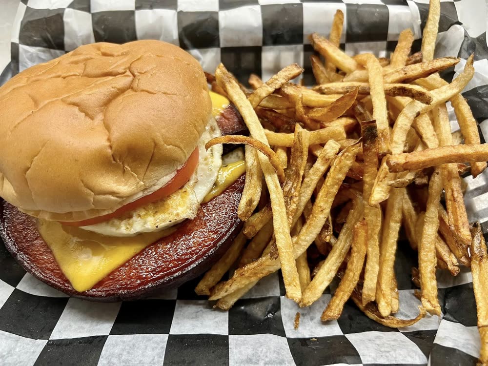 Fried bologna sandwich with egg and cheese, fries beside