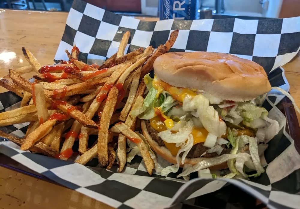 Cheeseburger with shredded lettuce, fries with ketchup