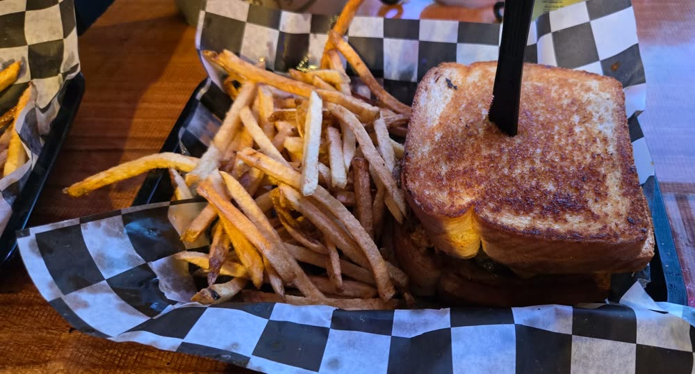 The Not So Slim with a knife through the top, fries beside